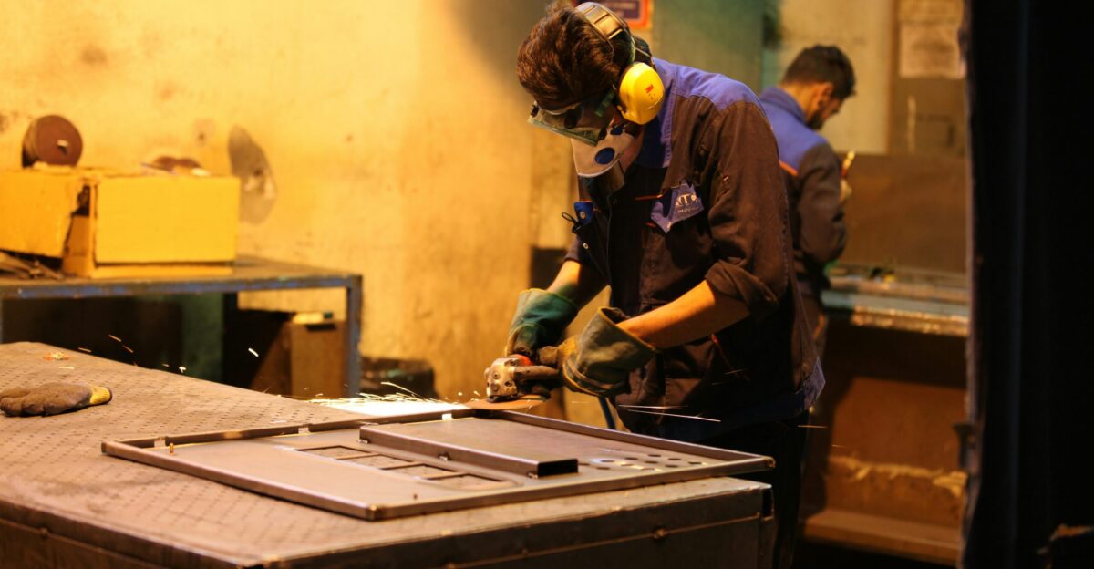 man in blue shirt and green pants wearing yellow helmet