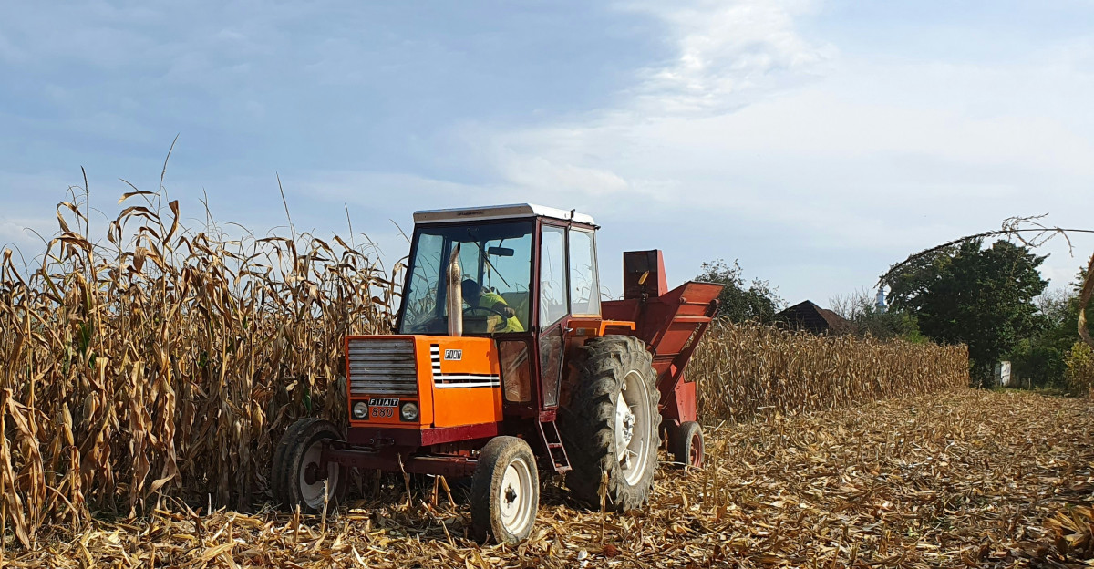 red and black tractor on brown field during daytime