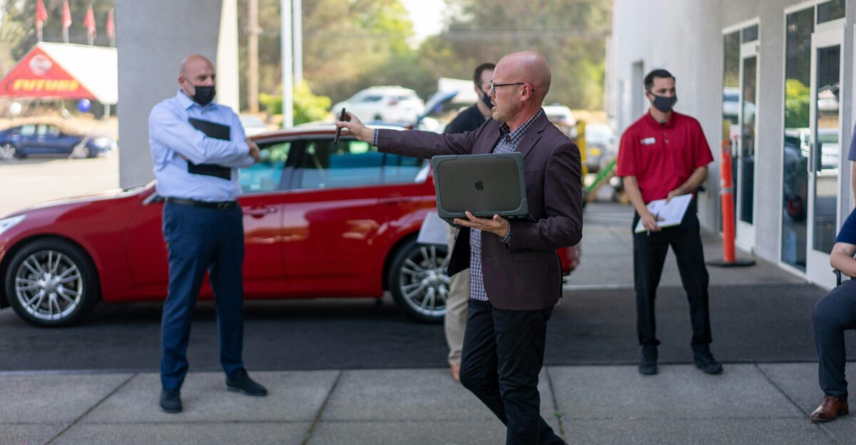 man in white dress shirt and black pants holding ipad