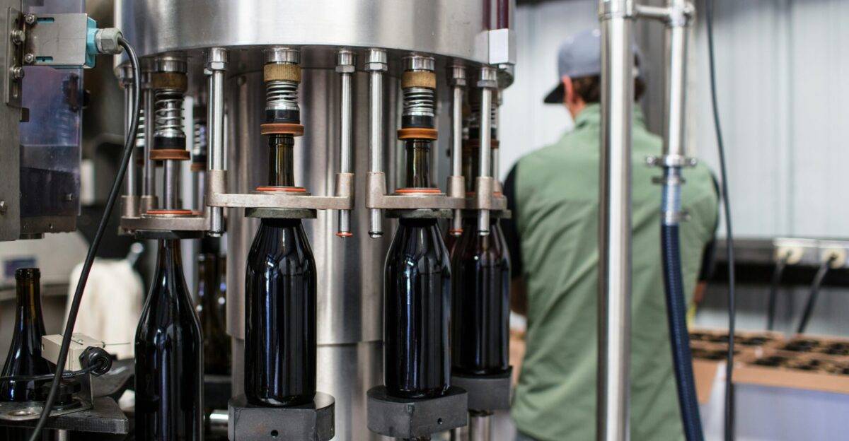 black glass bottles on stainless steel rack