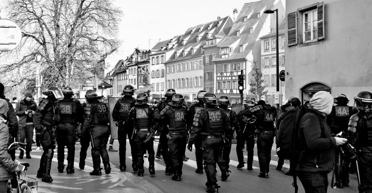grayscale photo of people walking on sidewalk