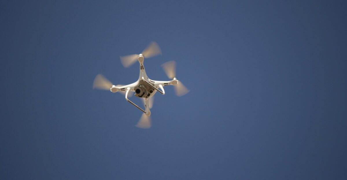 white and blue airplane in mid air