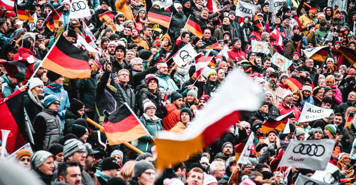 a large crowd of people holding flags and banners