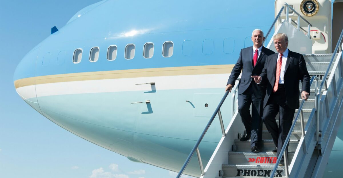man in black suit standing beside woman in black coat