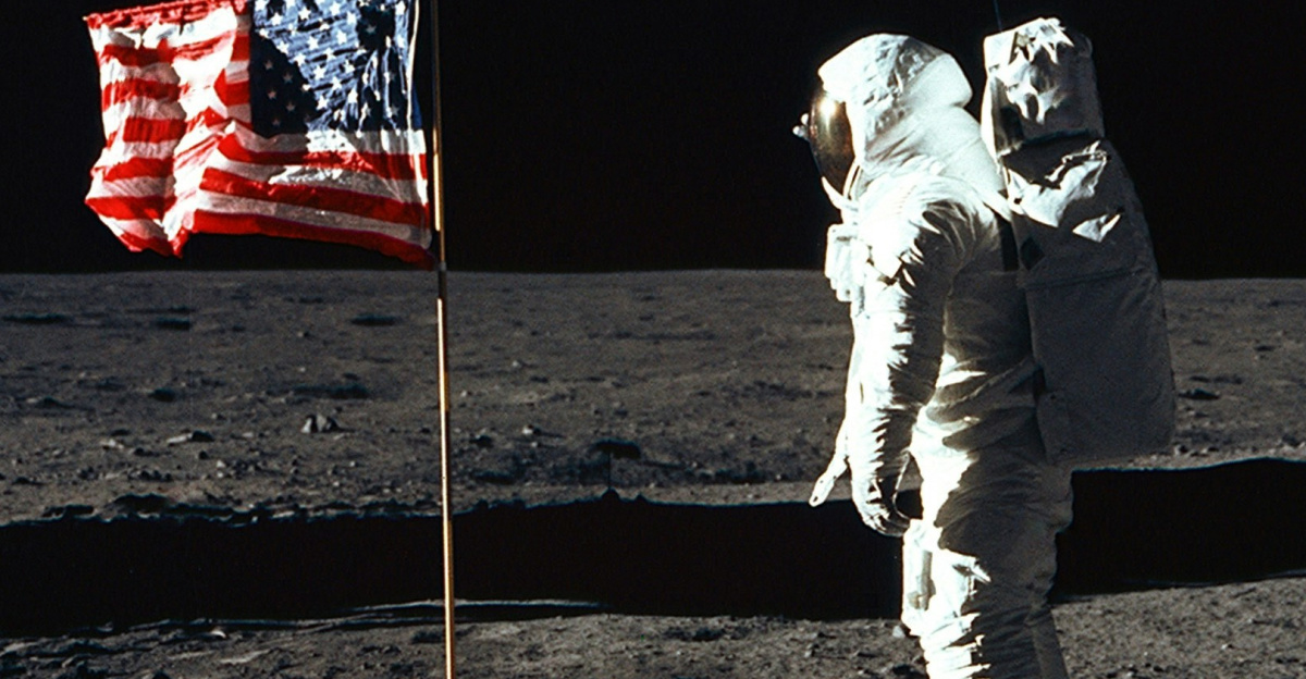 Buzz Aldrin on the moon in front of the US flag