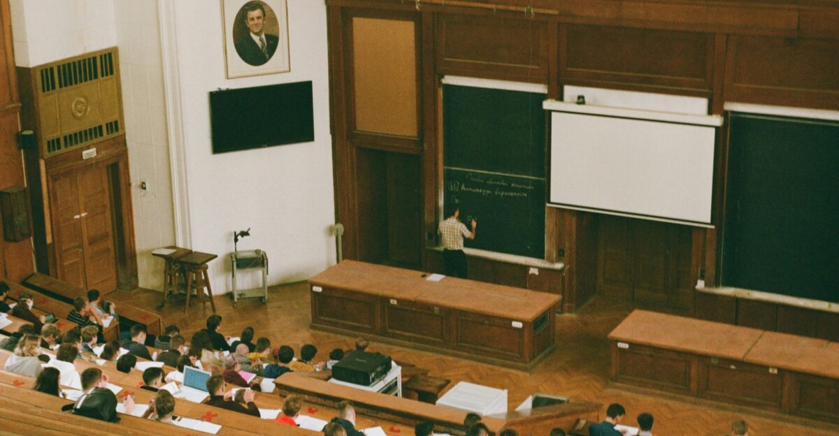people sitting on brown wooden bench