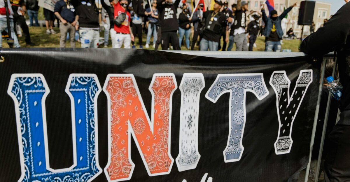 a group of people standing around a banner