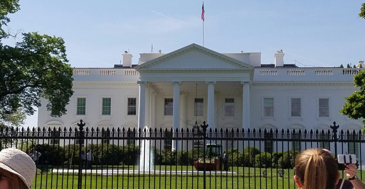 woman in black shirt sitting on black metal bench
