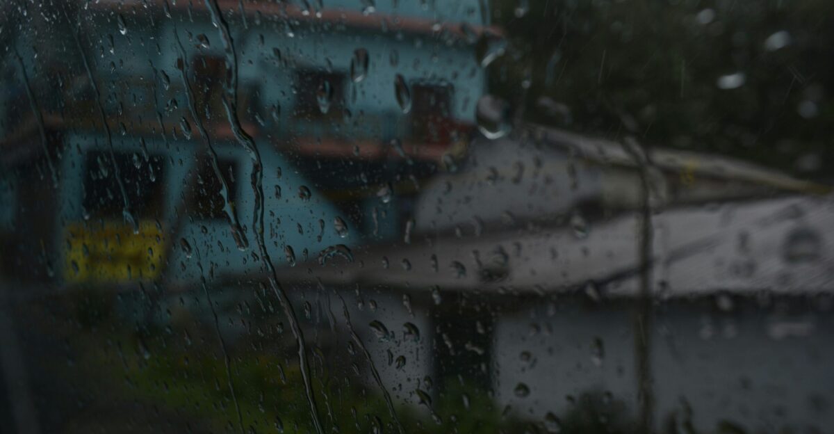 a view of a house through a rainy window