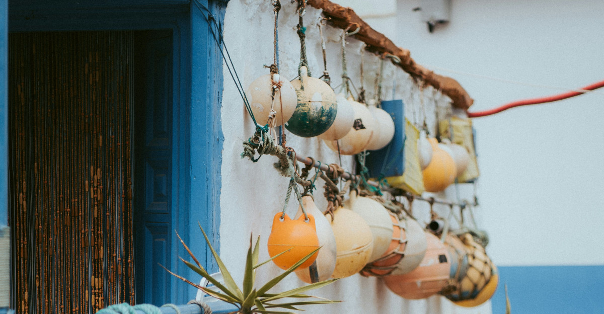 yellow and white sheep plush toy on blue metal fence