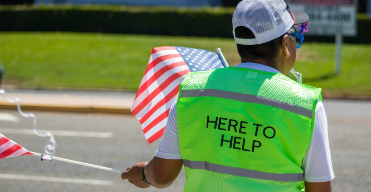 man in green and white adidas jersey shirt and white and blue fitted cap holding white