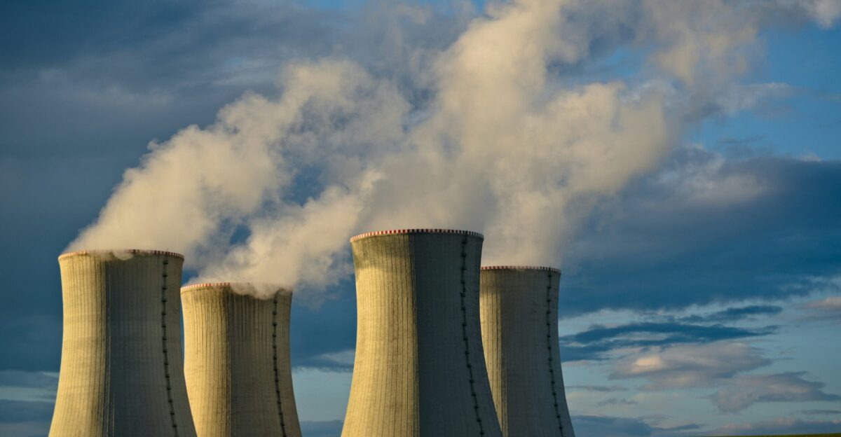 gray concrete towers under white clouds and blue sky during daytime