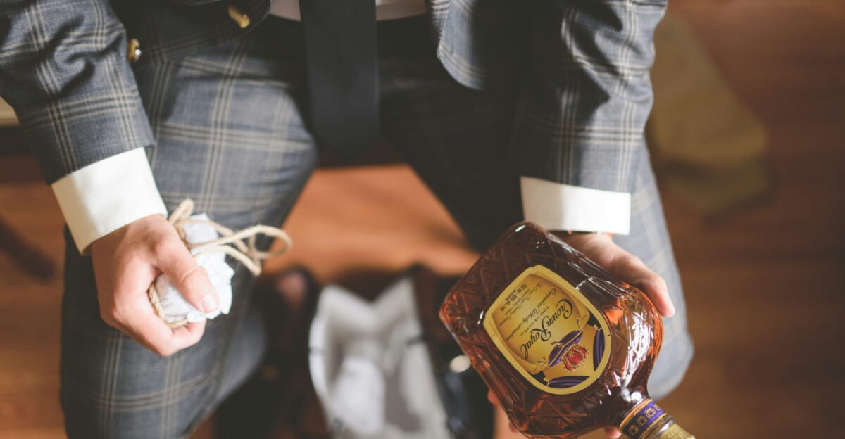 person in black leather jacket holding white earbuds