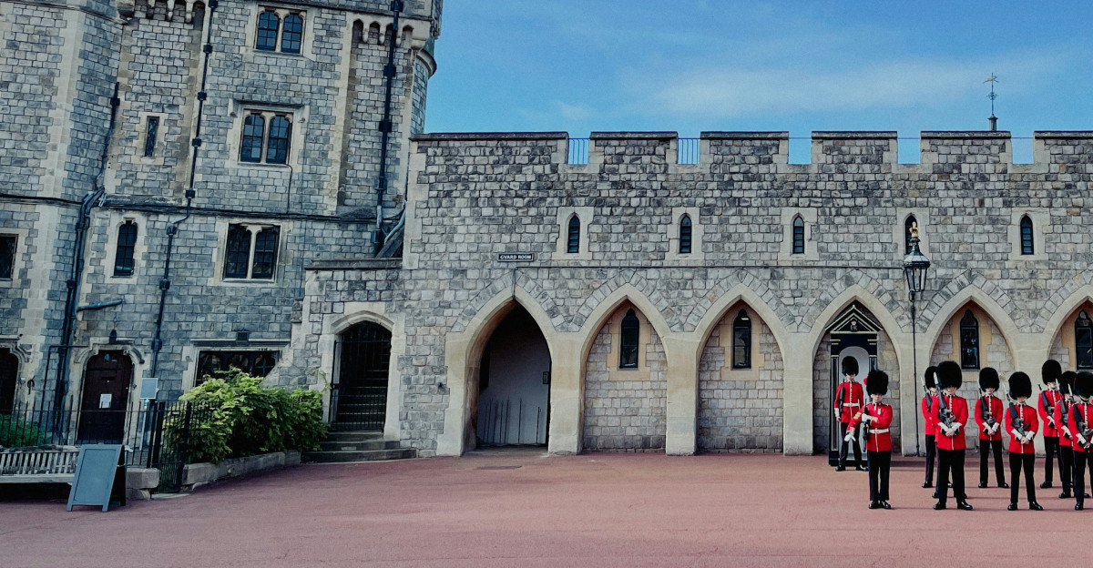 a group of people standing in front of a castle