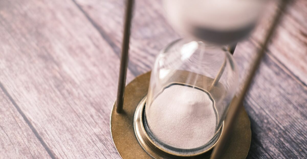 an hourglass sitting on top of a wooden table