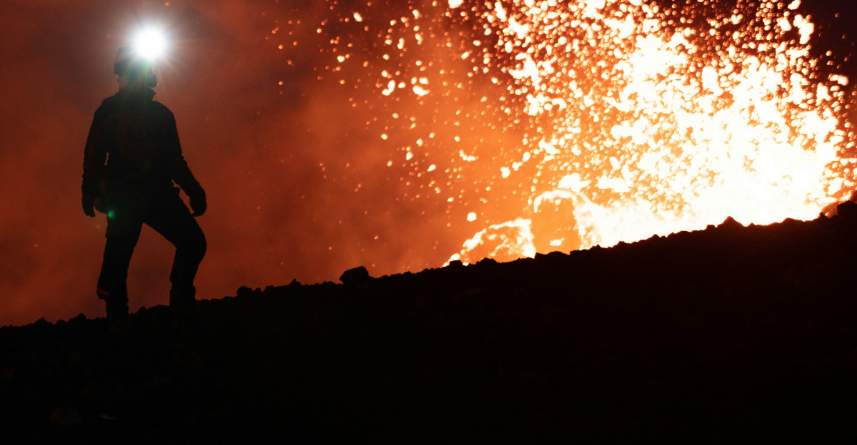 a couple of people standing on top of a hill