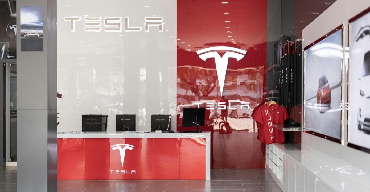 a tesla store with a red and white wall