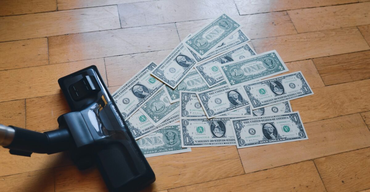 a pile of money sitting on top of a wooden floor