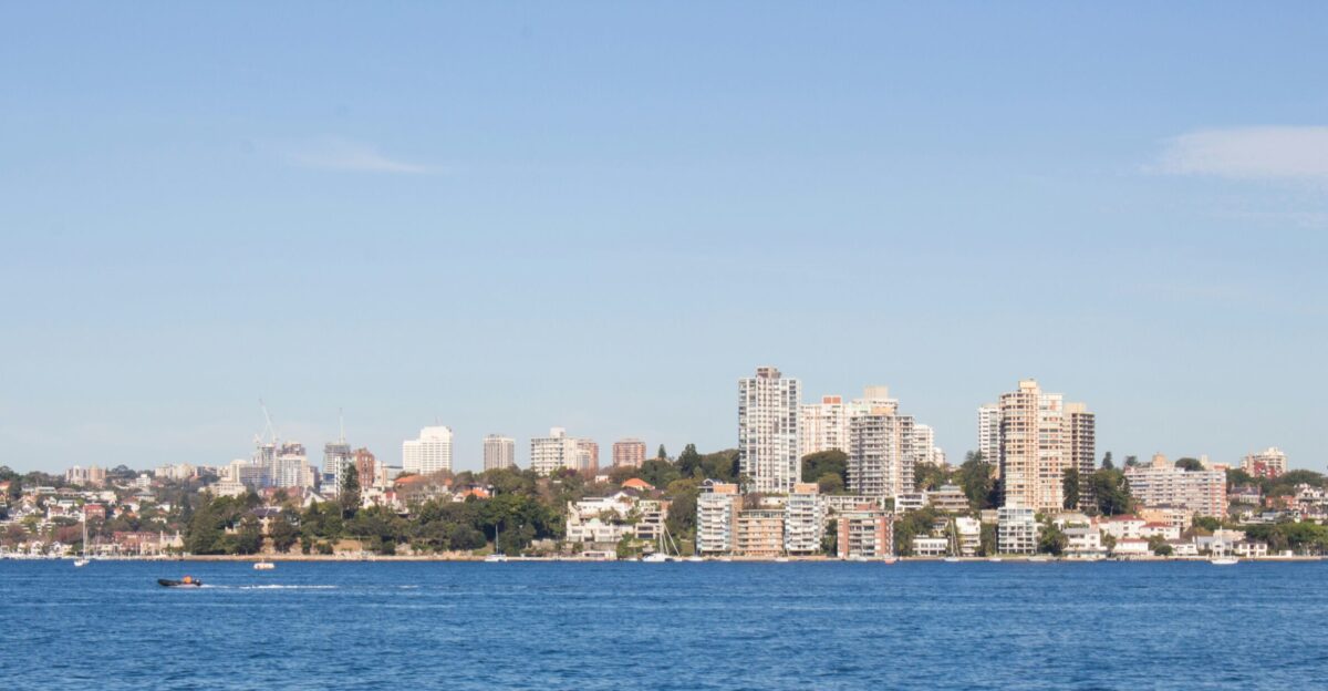 a large body of water with a city in the background