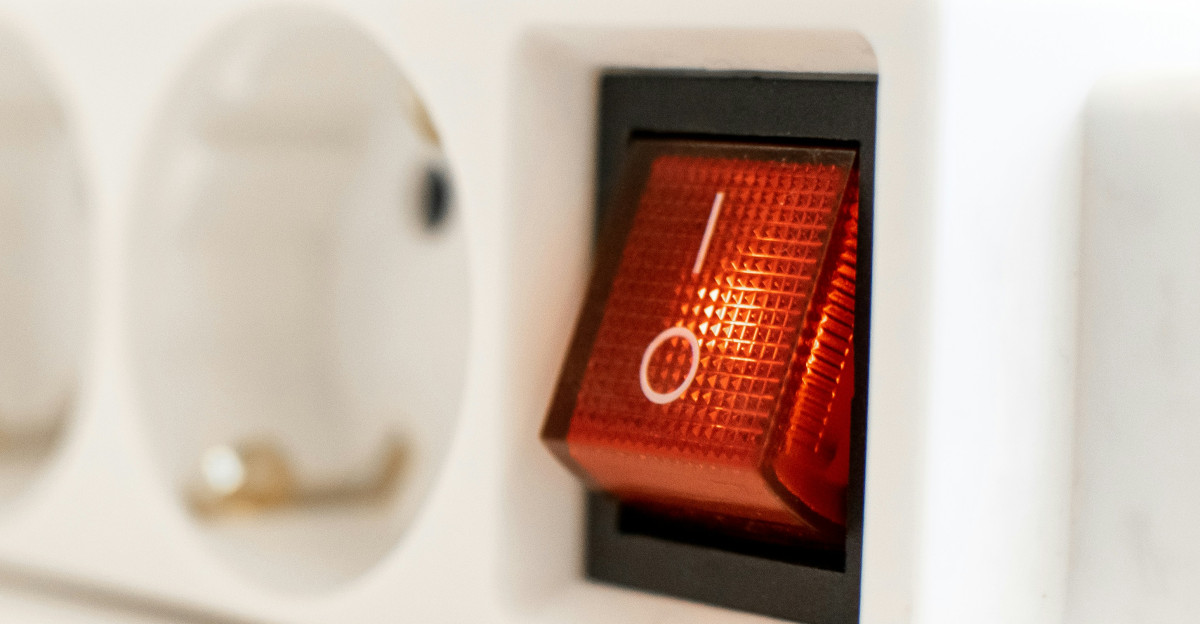 a close up of a red light on a white device