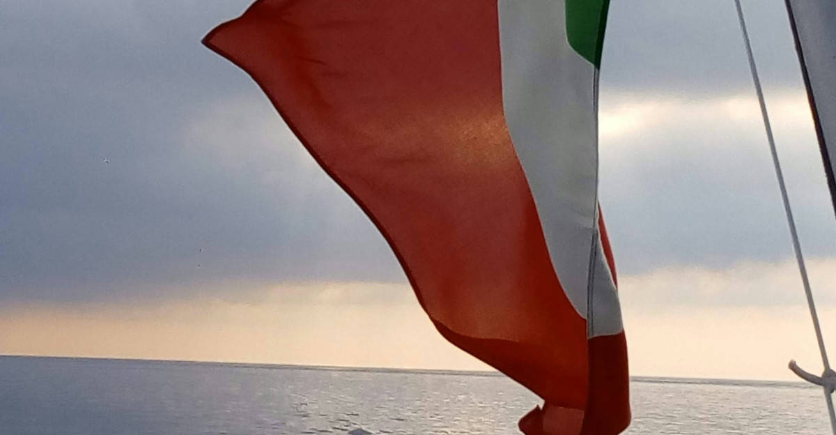 a flag on a boat in the ocean