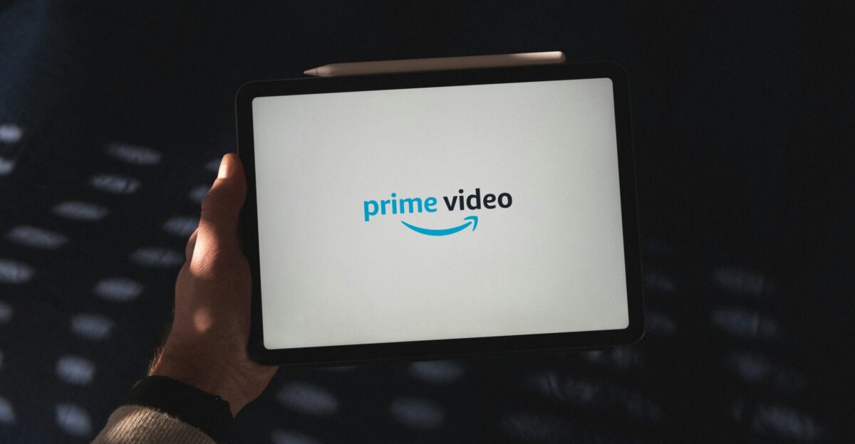 a person holding a tablet with a logo on it