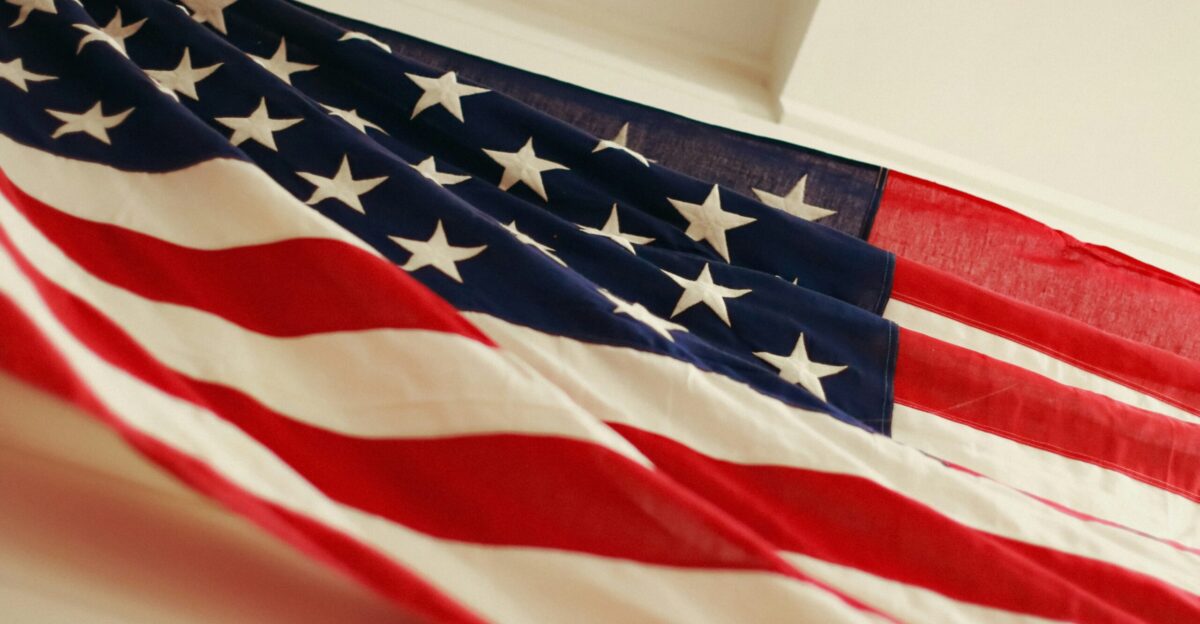 an american flag hanging on a wall
