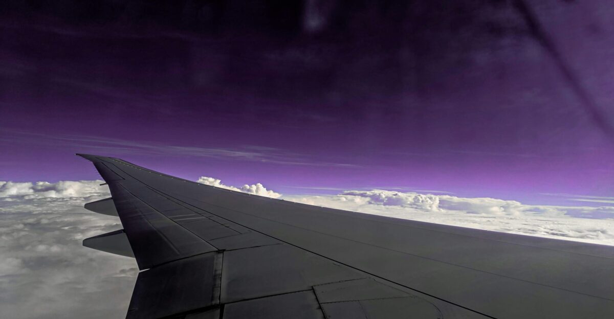 a view of the wing of an airplane in the sky