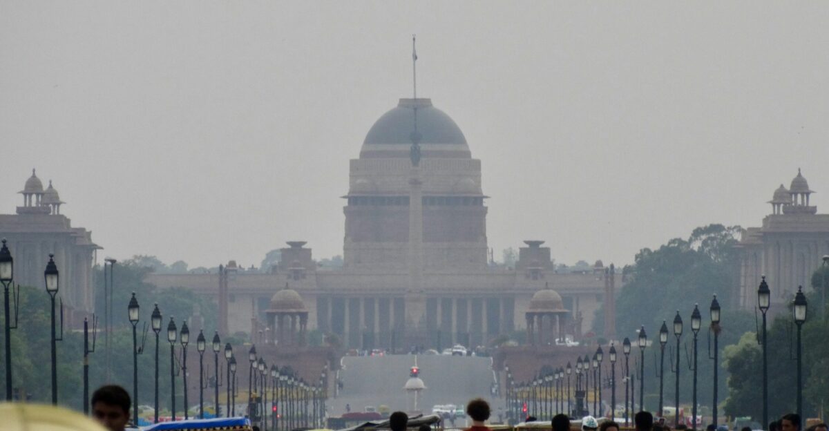 a group of people walking down a street next to tall buildings