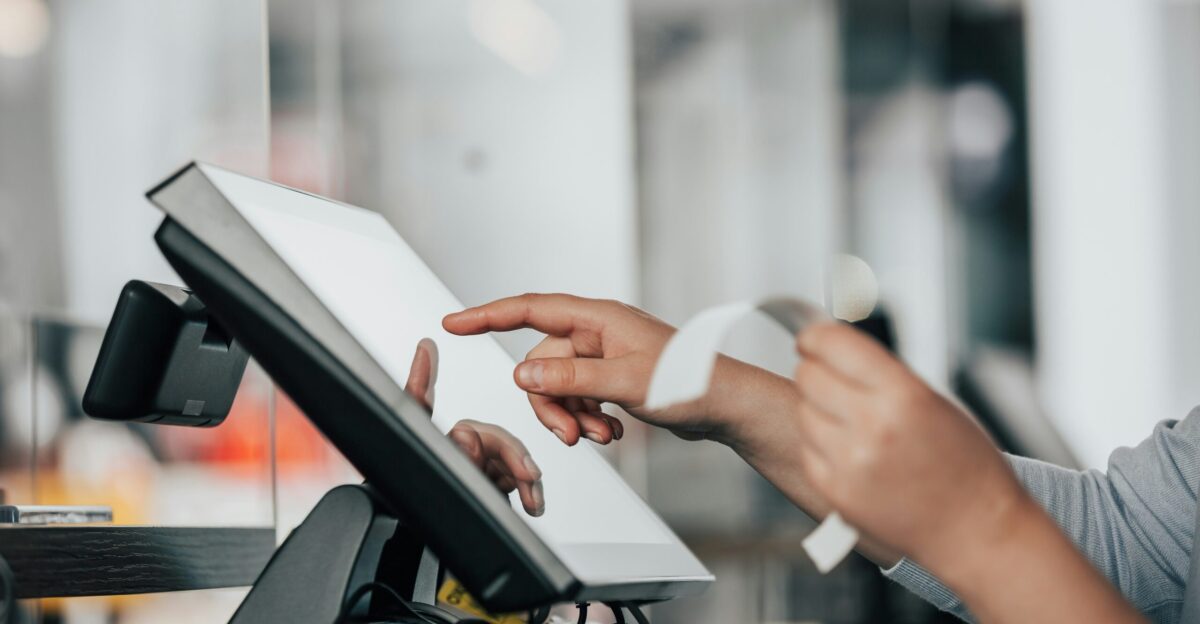 a person is using a pos machine in a store
