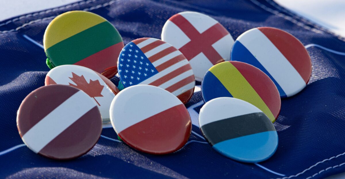 a bunch of buttons with flags on them