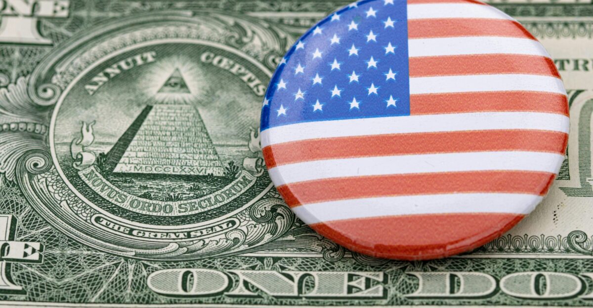 a button on top of a one dollar bill