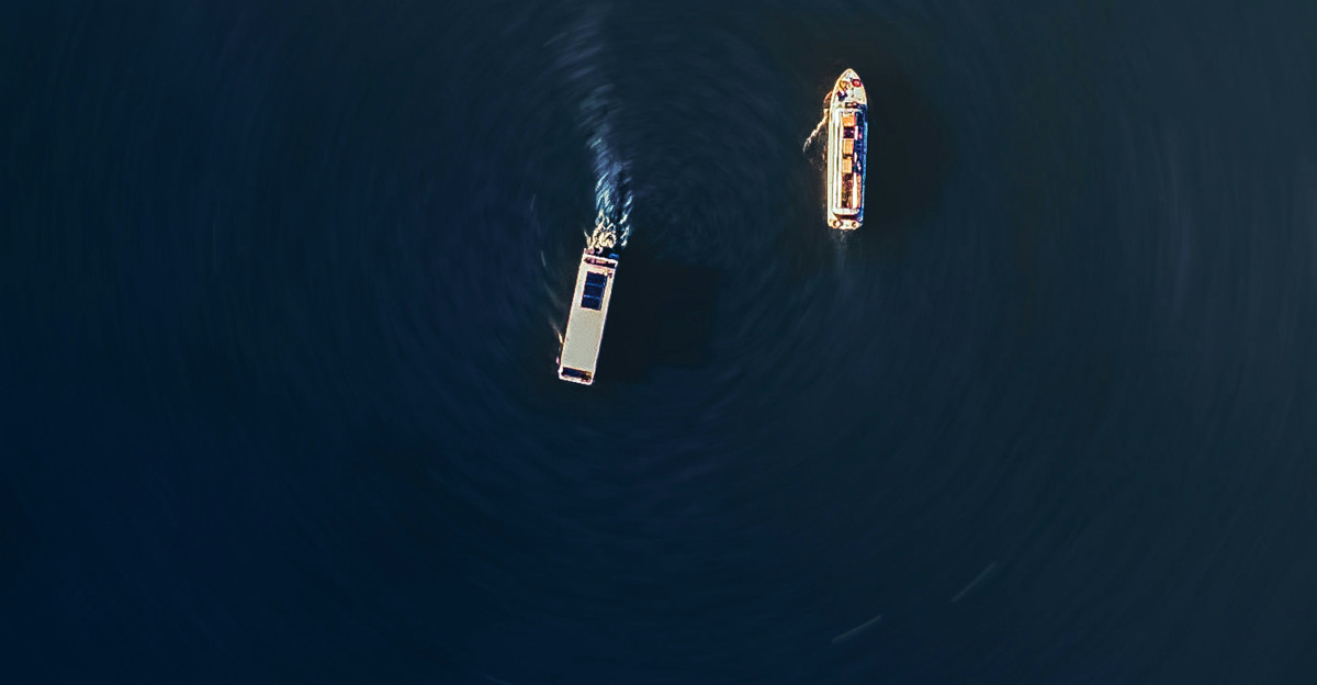 a couple of boats floating on top of a body of water