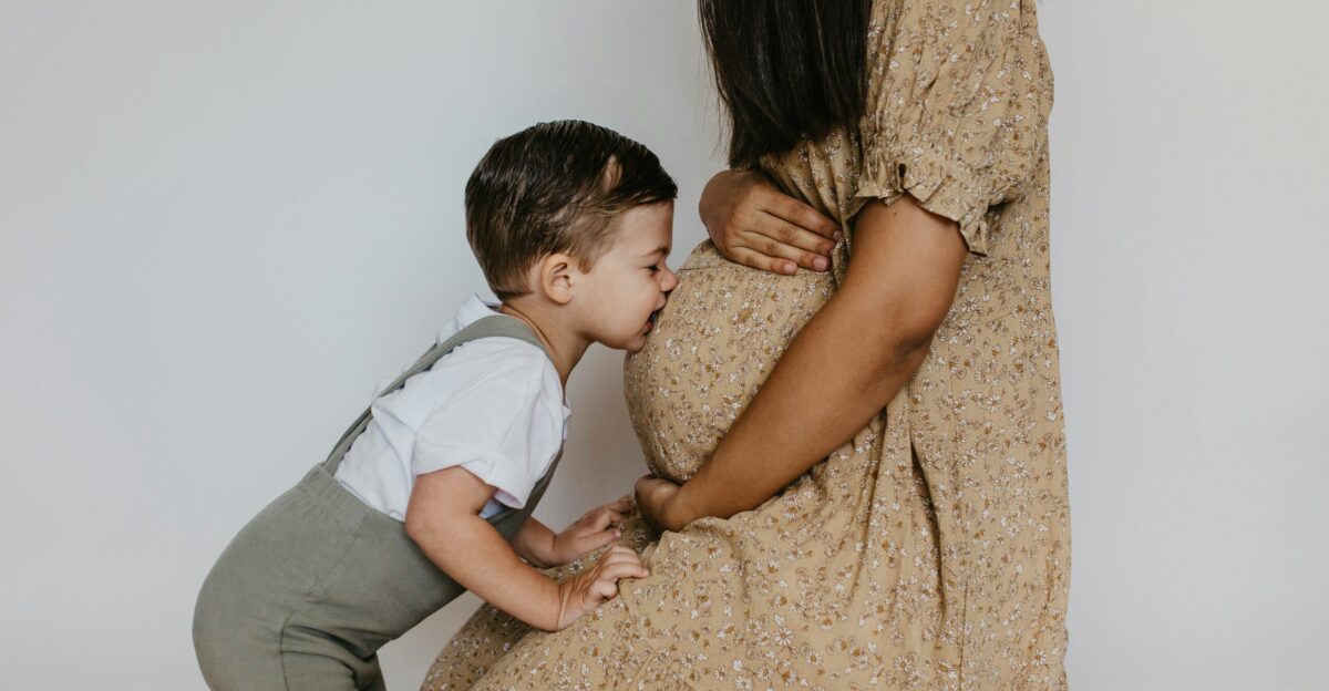 a woman holding a baby boy and kissing him