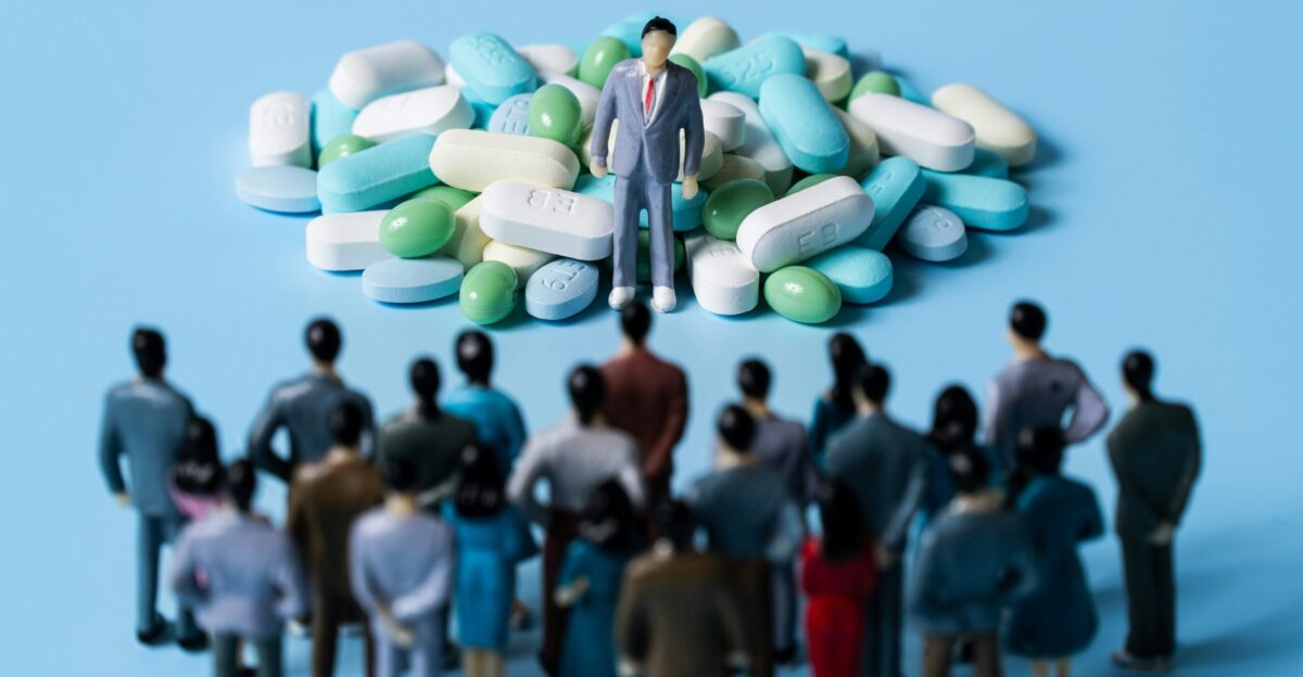 a group of people standing around a person holding a sign