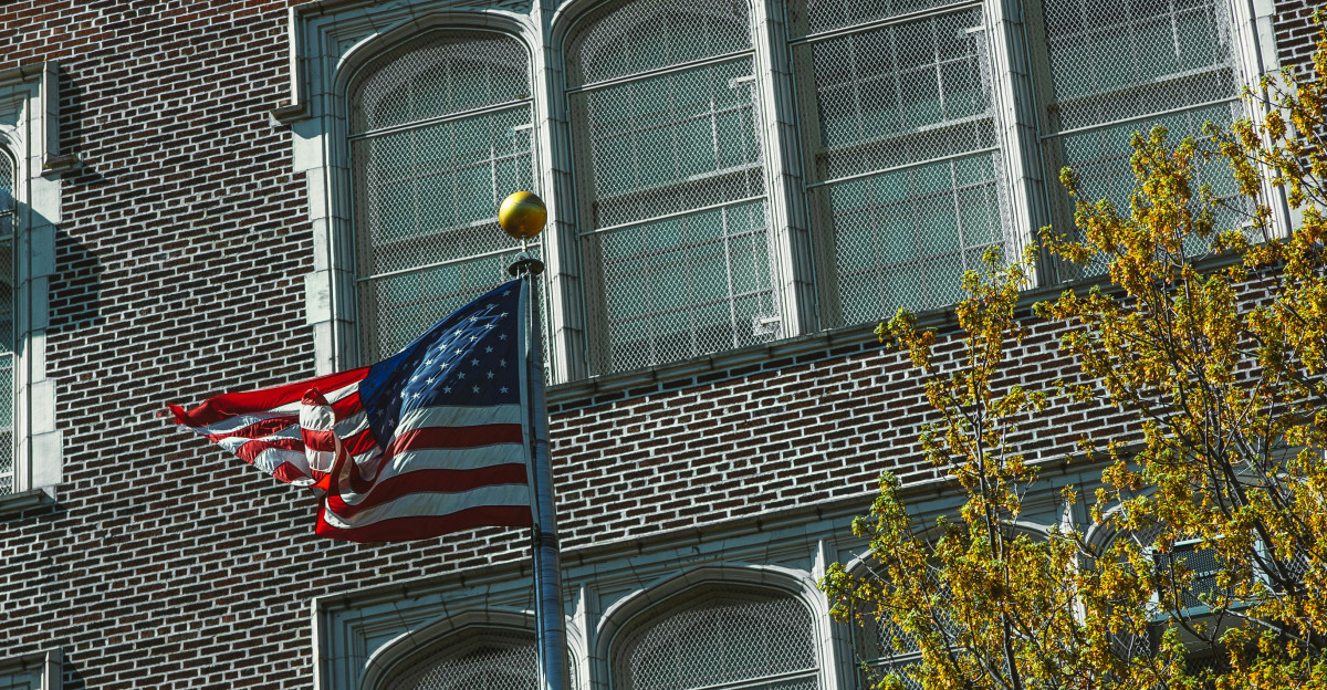 a flag on a pole in front of a building