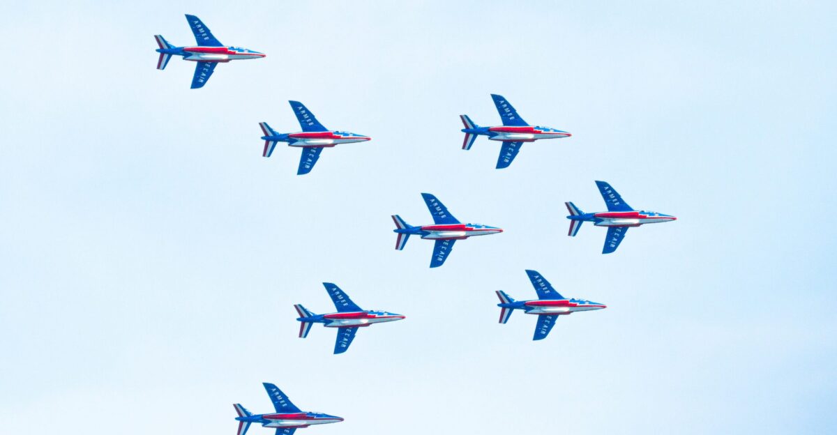 a group of blue airplanes flying in the sky