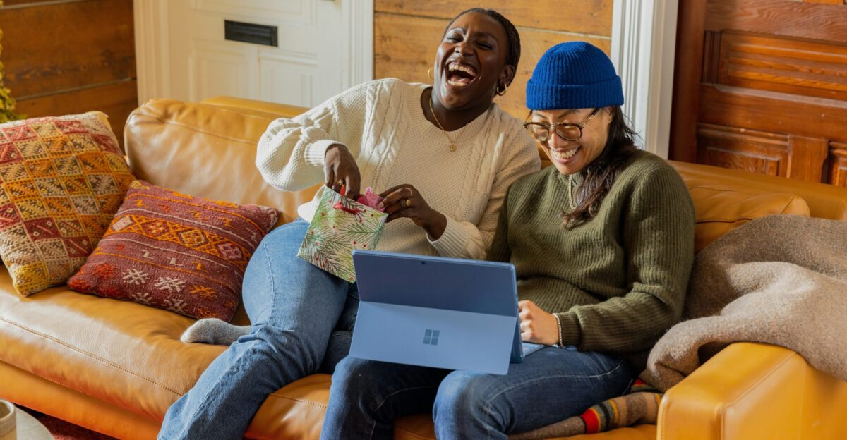 a person sitting on a couch with a laptop