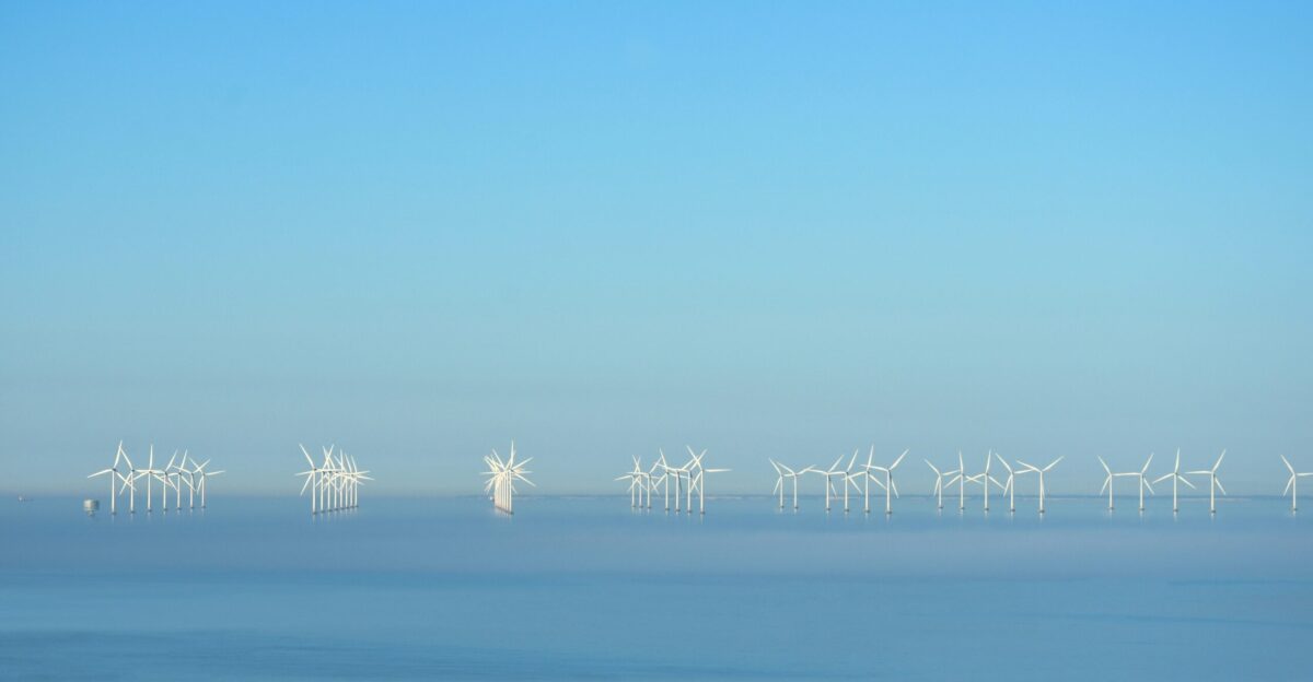 a group of wind turbines in the water