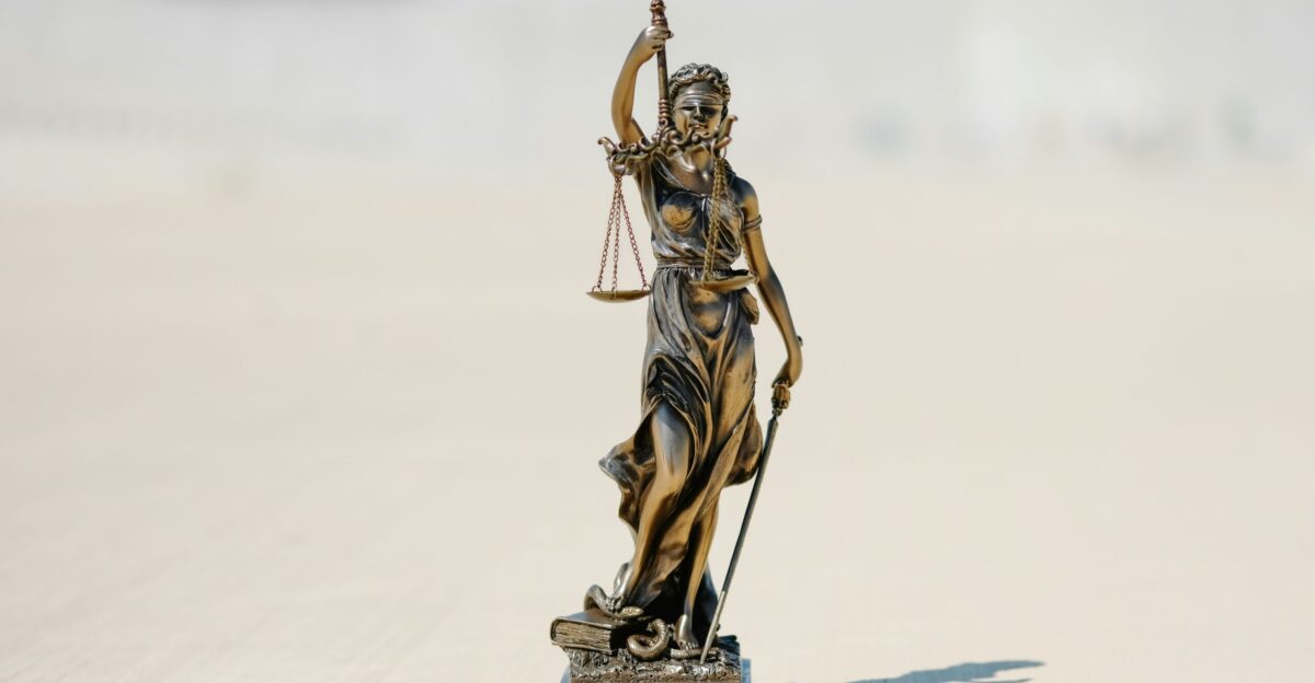 a statue of a person holding a staff