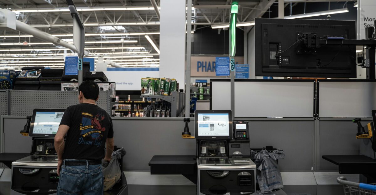 a person standing in a room with computers and other equipment