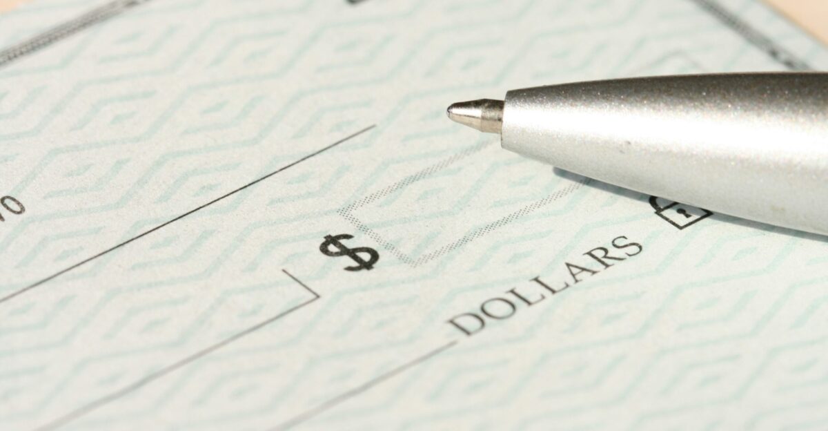a pen sitting on top of a cheque paper
