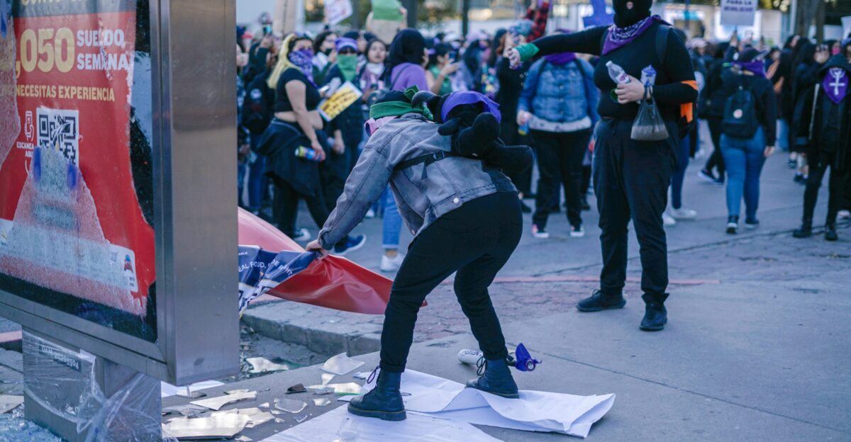 a group of people standing on a street next to a building
