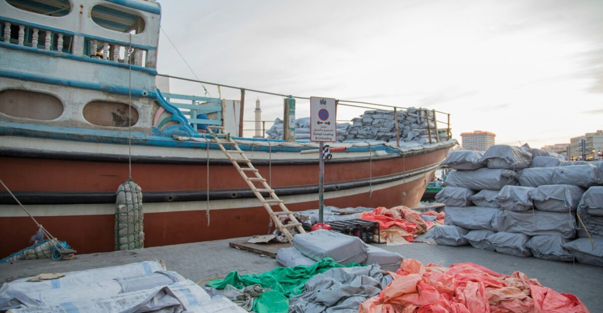 a large boat sitting next to a pile of bags