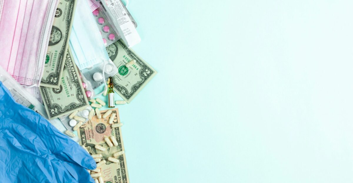 a medical mask medical supplies and money on a blue background