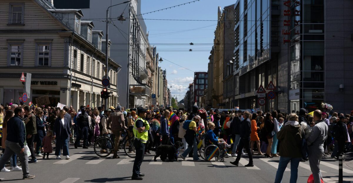 a crowd of people walking across a street