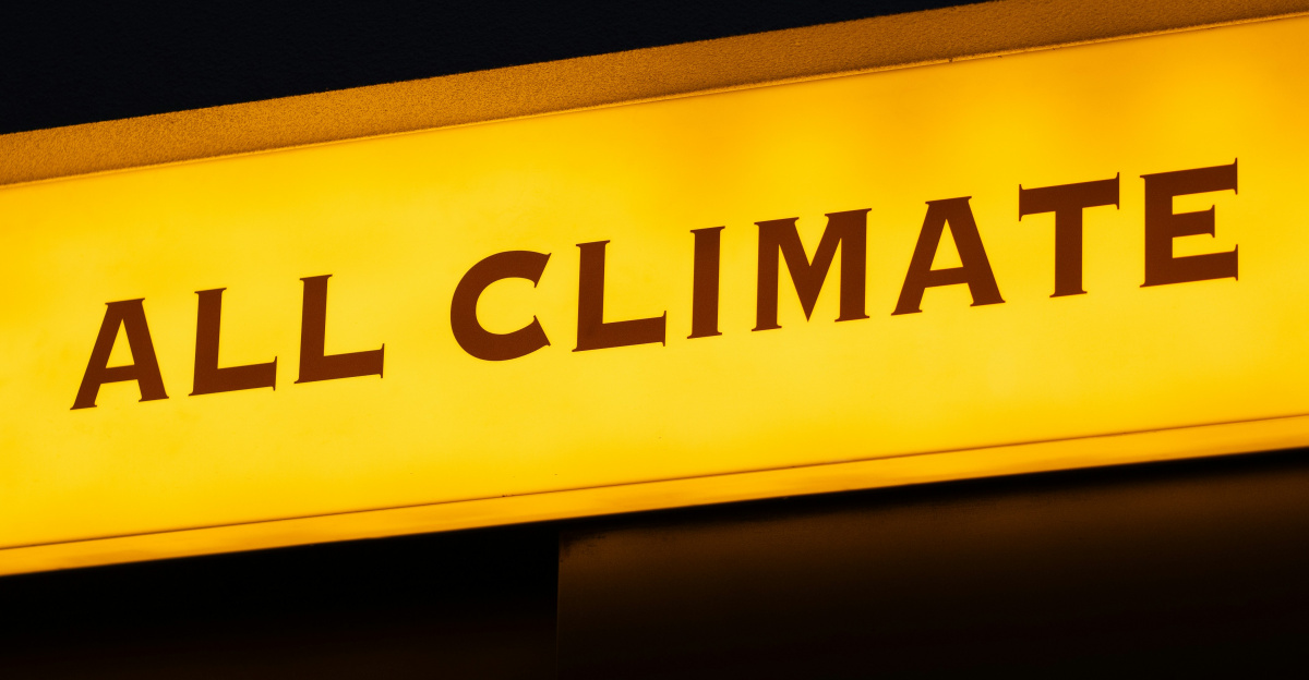 a yellow sign that says all climate on it