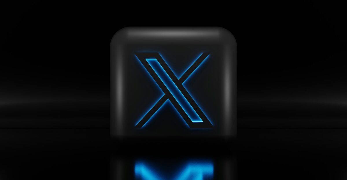 a blue illuminated letter x on a black background