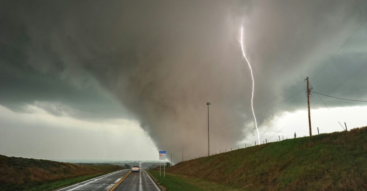 a large storm is coming down on a highway