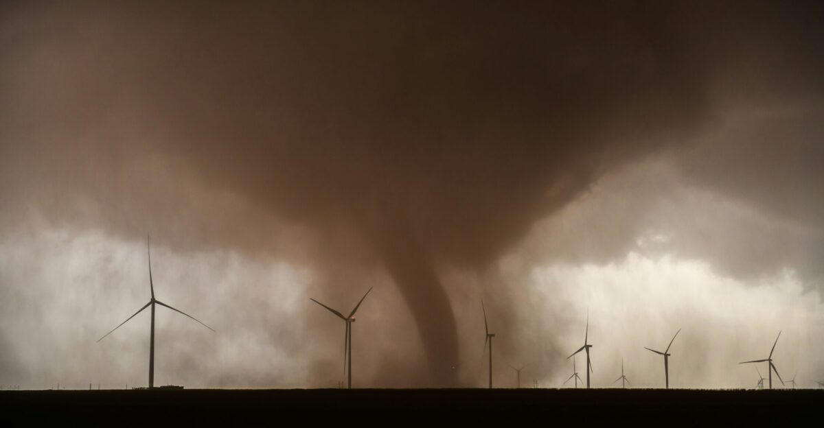 a large tornado is coming out of a field